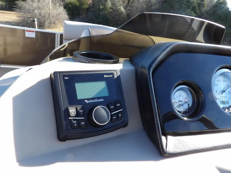 Slide: The Image of 2025 Bennington S Quad Bench 21 SSR dashboard with control panel and gauges. - 24