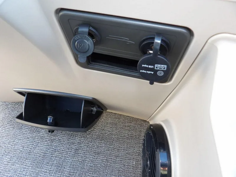 Slide: The Image of 2025 Bennington S Quad Bench 21 SSR interior with power outlets and storage compartment. - 28