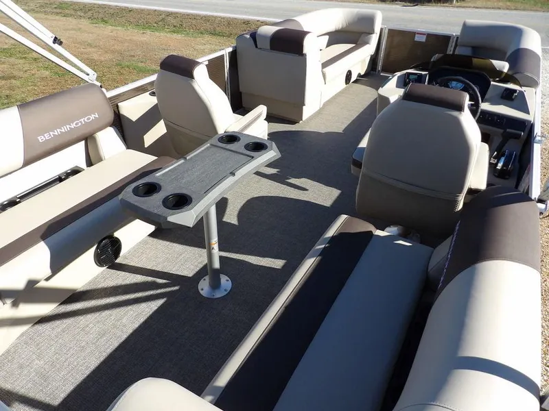 Slide: The Image of 2025 Bennington S Quad Bench 21 SSR pontoon boat interior with seating and table. - 32