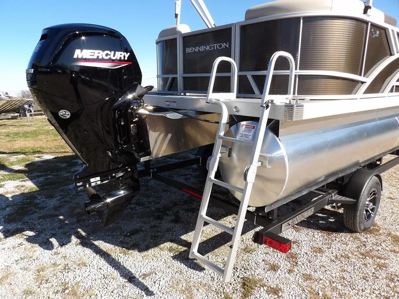 Slide: The Image of 2025 Bennington S Quad Bench 21 SSR pontoon boat with Mercury engine and ladder. - 34