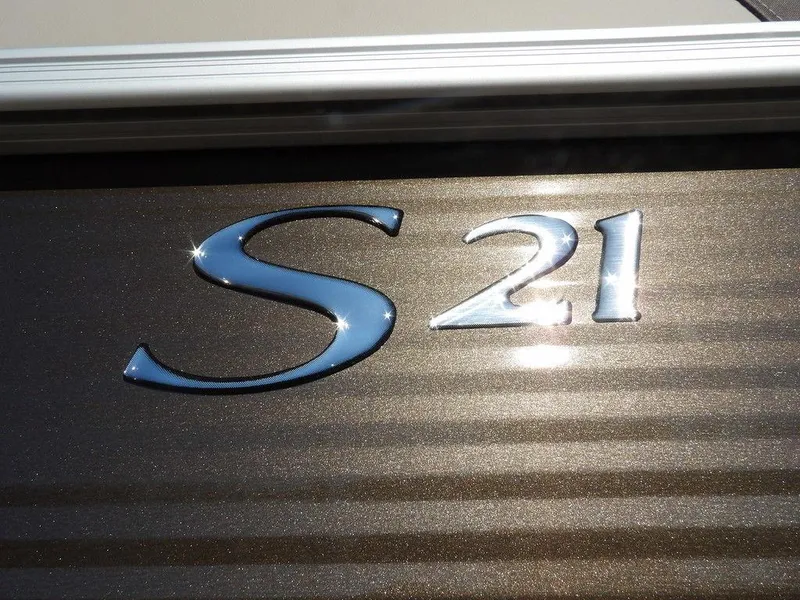 Slide: The Image of Bennington S Quad Bench 21 SSR 2025 model emblem with shiny metallic finish. - 38