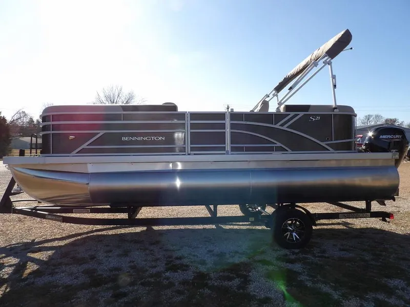 Slide: The Image of 2025 Bennington S Quad Bench 21 SSR pontoon boat on trailer, side view. - 5