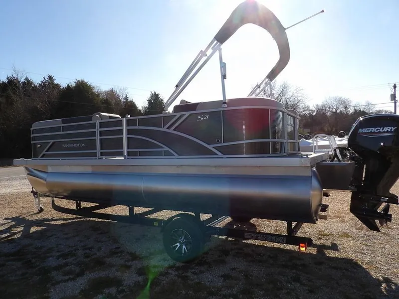 Slide: The Image of 2025 Bennington S Quad Bench 21 SSR pontoon boat with Mercury outboard engine. - 6