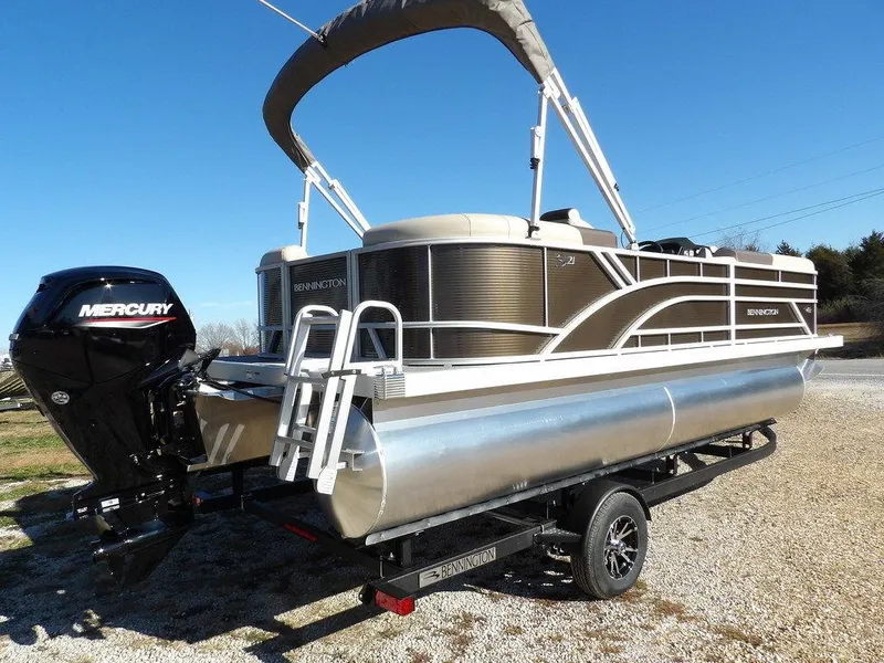 Slide: The Image of 2025 Bennington S Quad Bench 21 SSR pontoon boat with Mercury engine on trailer. - 8