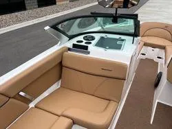 Slide: The Image of 2022 MasterCraft XT25 boat interior with tan seating and modern dashboard. - 11