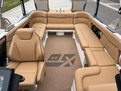Slide: The Image of 2022 MasterCraft XT25 boat interior with tan leather seating. - 12