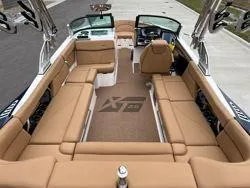 Slide: The Image of 2022 MasterCraft XT25 boat interior with tan seating and modern design. - 14