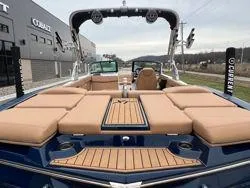 Slide: The Image of 2022 MasterCraft XT25 boat with tan seating and sleek design. - 15