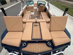 Slide: The Image of 2022 MasterCraft XT25 boat with tan seating and sleek design. - 16