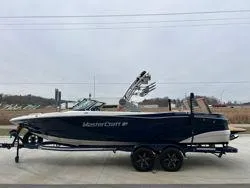 Slide: The Image of 2022 MasterCraft XT25 boat on trailer, side view, outdoors. - 7