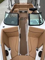 Slide: The Image of 2022 MasterCraft XT25 boat interior with tan seating and modern design. - 9