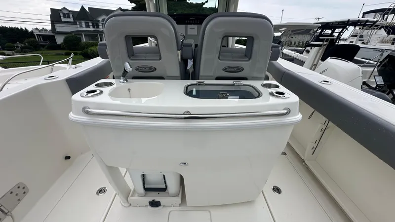 Slide: The Image of 2025 Boston Whaler 280 Outrage boat interior with seating and sink. - 16