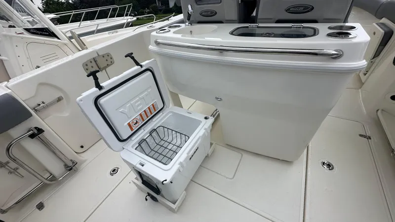 Slide: The Image of 2025 Boston Whaler 280 Outrage boat interior with open YETI cooler. - 17
