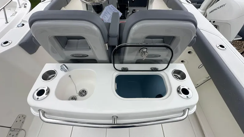 Slide: The Image of 2025 Boston Whaler 280 Outrage boat interior with sink and storage compartments. - 19