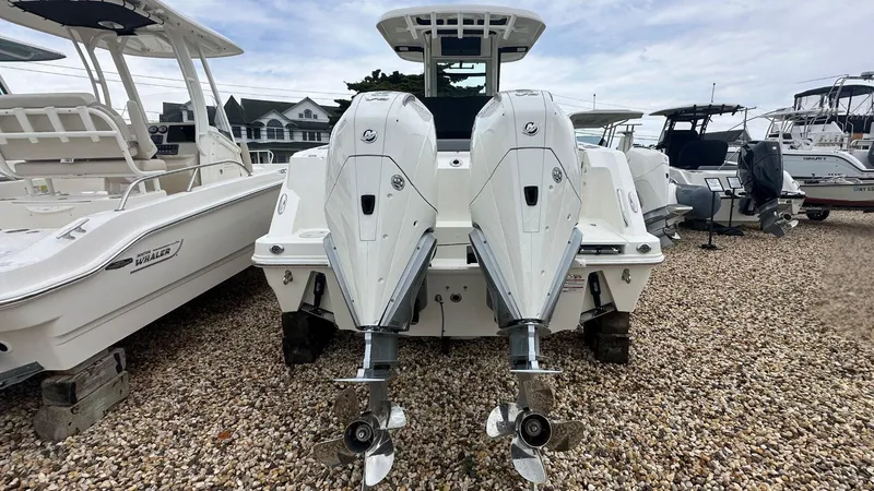 Slide: The Image of 2025 Boston Whaler 280 Outrage with dual outboard engines on display. - 2