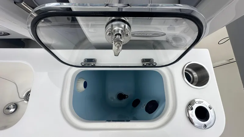 Slide: The Image of Livewell compartment on a 2025 Boston Whaler 280 Outrage boat, featuring a transparent lid. - 20