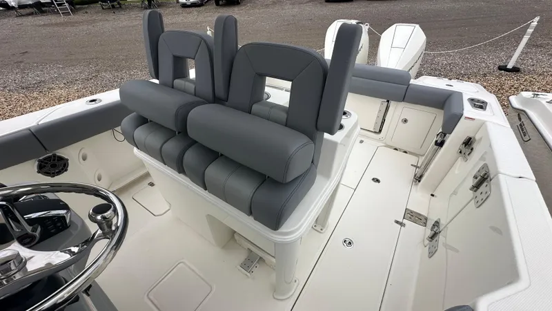 Slide: The Image of 2025 Boston Whaler 280 Outrage boat interior with gray seating and dual engines. - 21
