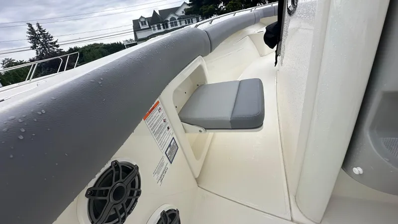 Slide: The Image of 2025 Boston Whaler 280 Outrage interior with seating and speaker detail. - 25