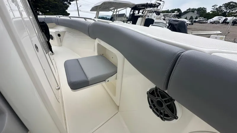 Slide: The Image of 2025 Boston Whaler 280 Outrage interior with gray seating and speaker detail. - 26
