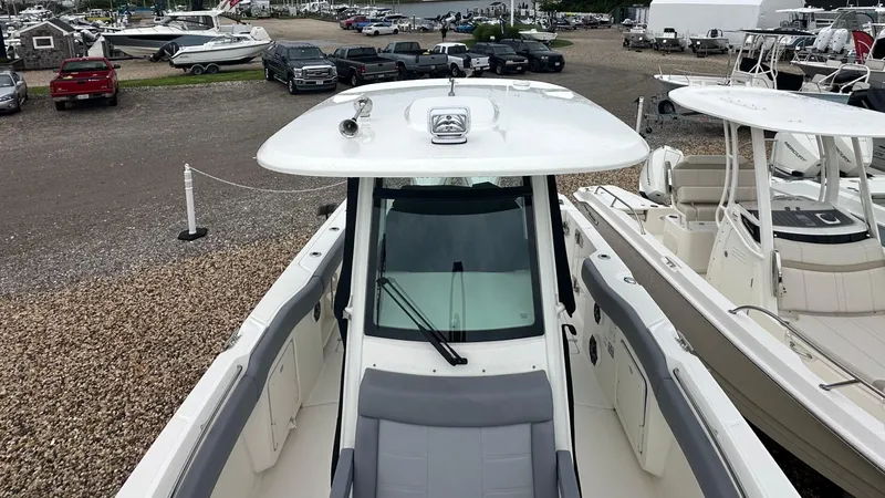 Slide: The Image of 2025 Boston Whaler 280 Outrage boat displayed in a marina setting. - 32