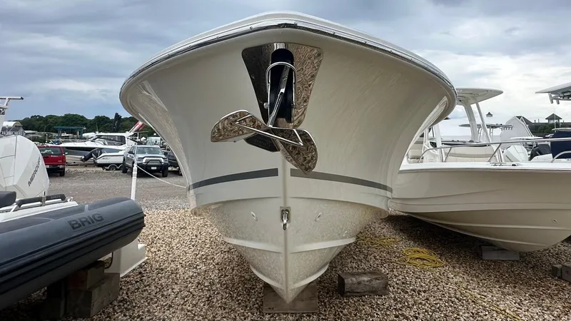 Slide: The Image of 2025 Boston Whaler 280 Outrage boat displayed on gravel lot. - 38