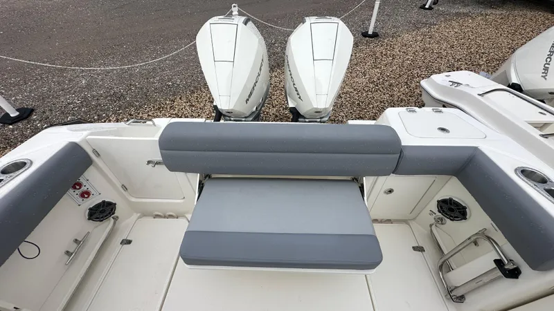 Slide: The Image of 2025 Boston Whaler 280 Outrage boat interior with dual Mercury engines and seating area. - 8