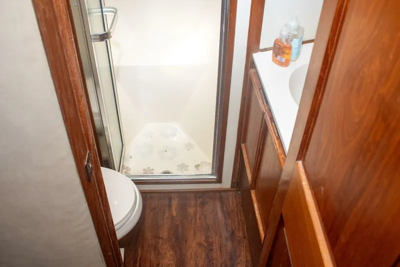 Slide: The Image of Bathroom interior of 1988 Chris-Craft 500 Constellation yacht with shower and wooden cabinetry. - 18