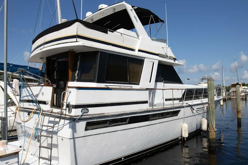 Slide: The Image of 1988 Chris-Craft 500 Constellation yacht docked at marina under clear blue sky. - 3