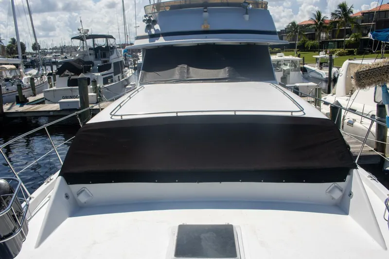 Slide: The Image of 1988 Chris-Craft 500 Constellation yacht docked at marina under cloudy sky. - 4