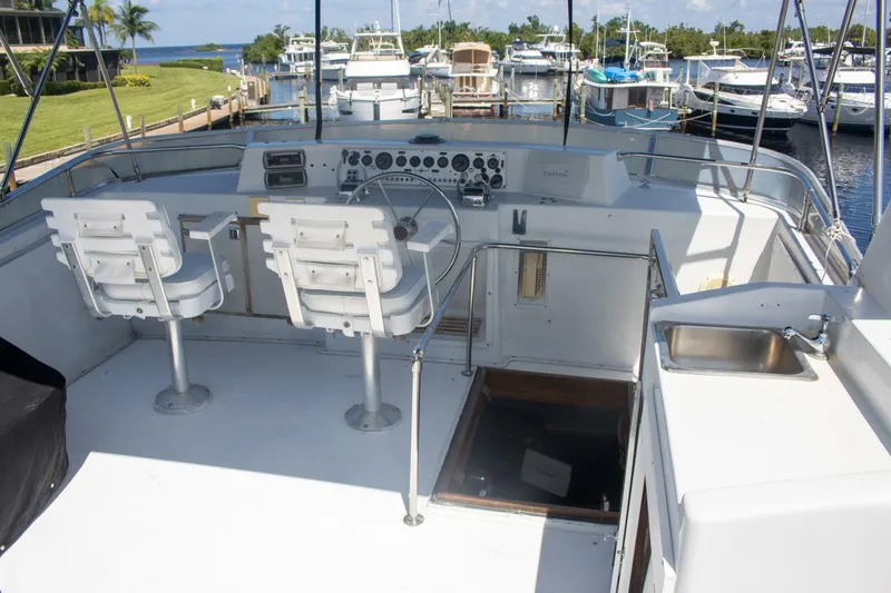 Slide: The Image of 1988 Chris-Craft 500 Constellation yacht helm with dual seats and marina view. - 6