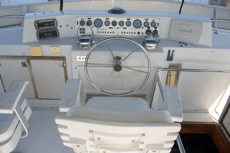 Slide: The Image of 1988 Chris-Craft 500 Constellation helm with steering wheel and navigation instruments. - 9