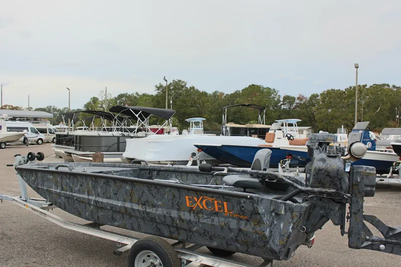The Image of Excel Eclipse 1554 boat on trailer, 2025 model, in a marina setting. - 1
