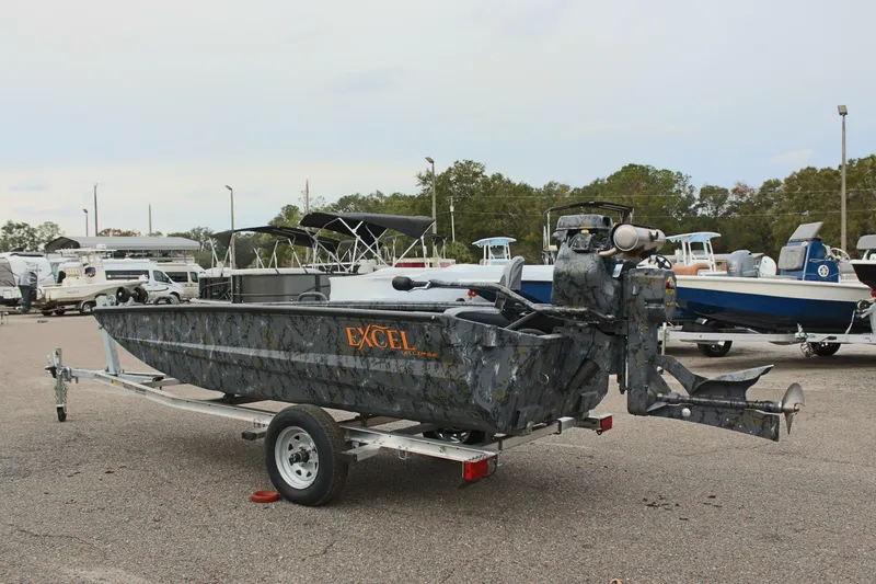 Slide: The Image of 2025 Excel Eclipse 1554 boat on trailer in parking lot. - 11