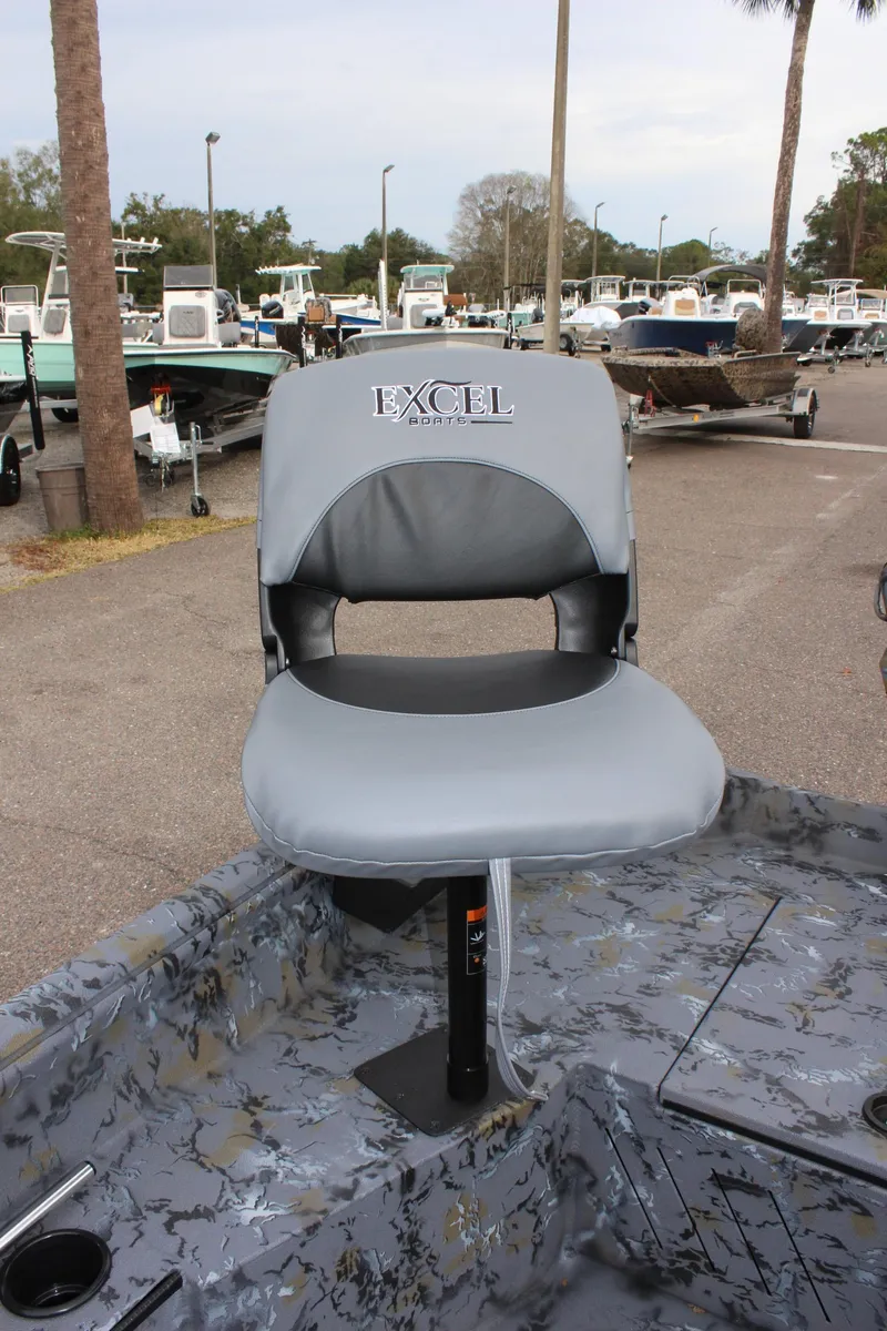 Slide: The Image of 2025 Excel Eclipse 1554 boat seat in a marina setting. - 14