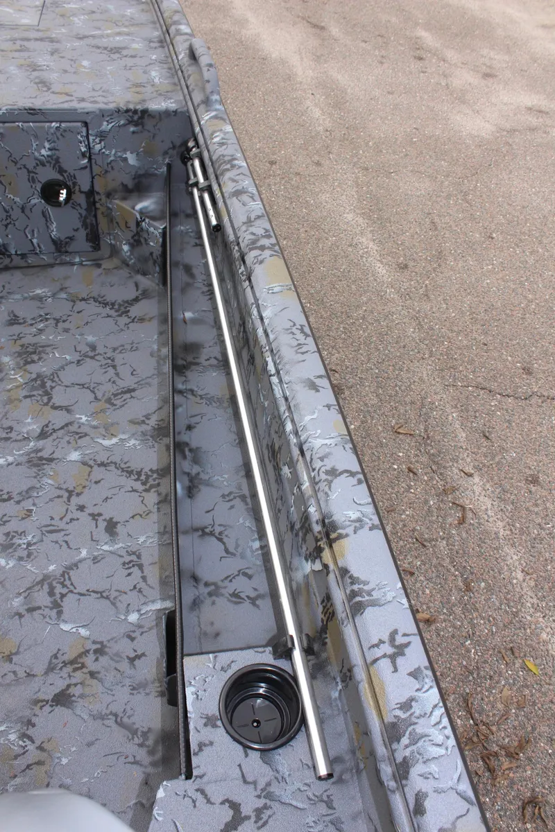 Slide: The Image of Excel Eclipse 1554 boat interior, 2025 model, featuring camo design and rod holder. - 16