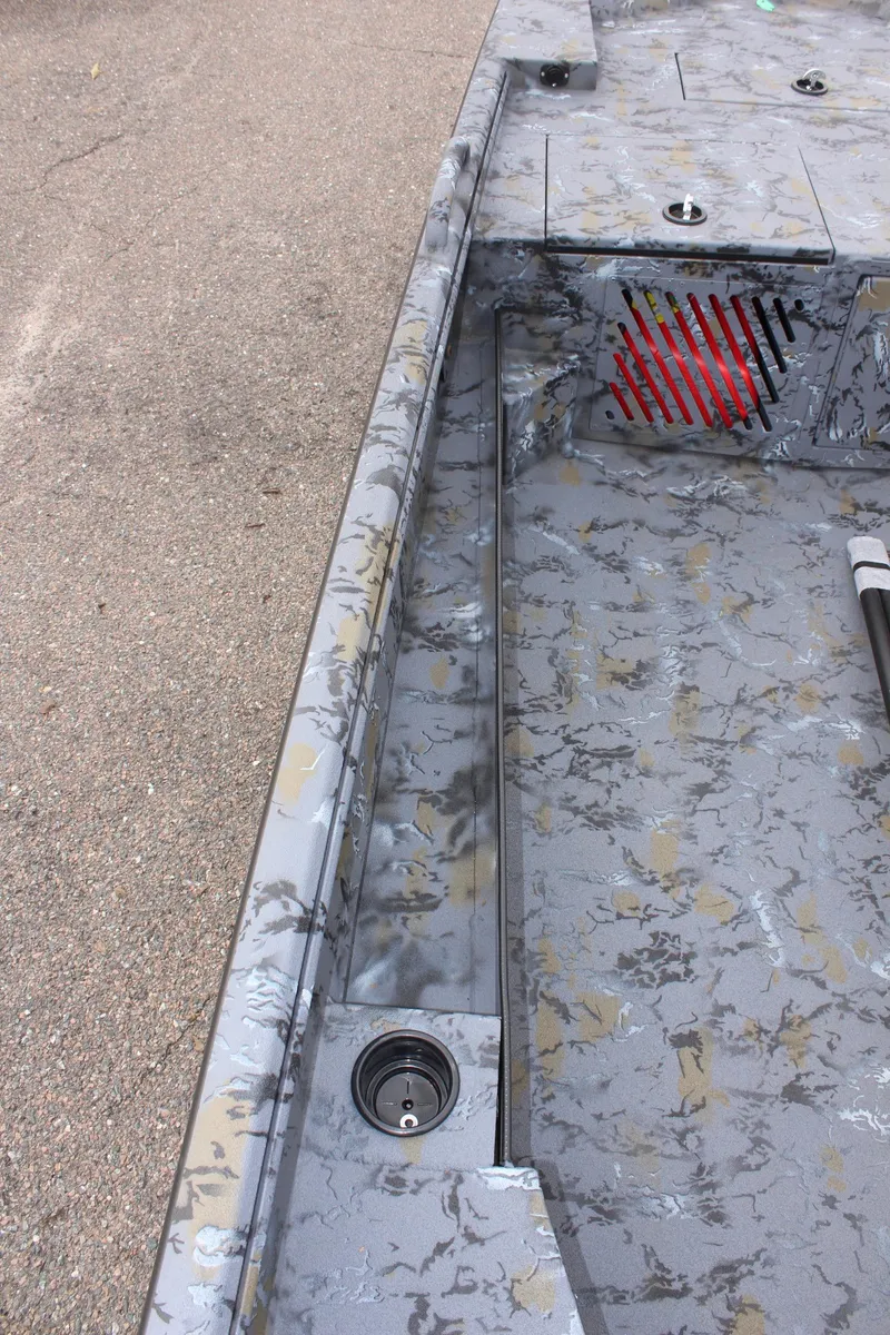 Slide: The Image of Excel Eclipse 1554 boat interior, 2025 model, with camo pattern and storage compartments. - 17