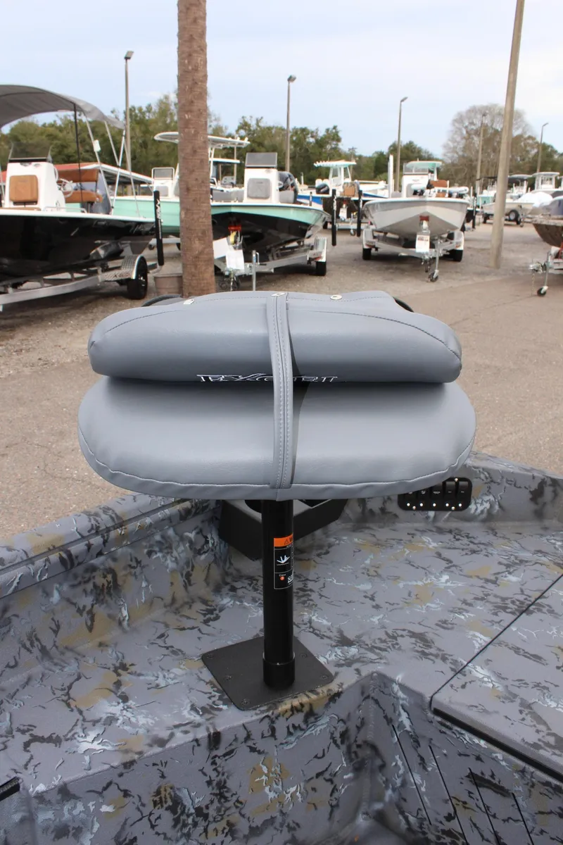 Slide: The Image of Gray seat on 2025 Excel Eclipse 1554 boat, parked among other boats. - 18