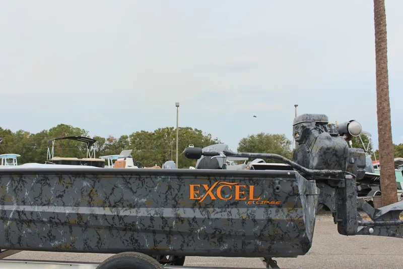 Slide: The Image of 2025 Excel Eclipse 1554 boat with camouflage design on a trailer. - 2
