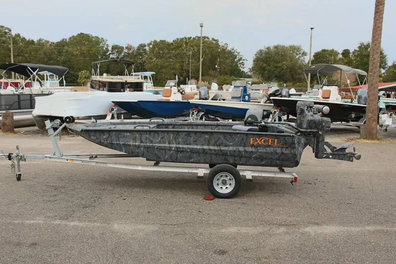 Slide: The Image of Excel Eclipse 1554 boat on trailer, parked in marina, 2025 model. - 4