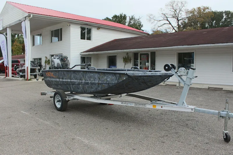 Slide: The Image of 2025 Excel Eclipse 1554 boat on trailer outside dealership. - 7
