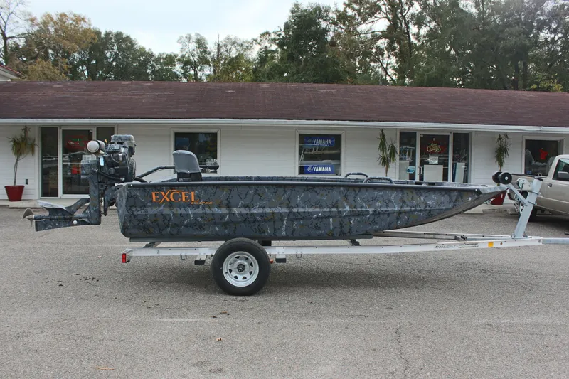 Slide: The Image of 2025 Excel Eclipse 1554 boat on trailer in front of a building. - 8