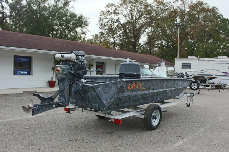 Slide: The Image of 2025 Excel Eclipse 1554 boat on trailer, parked outside dealership. - 9