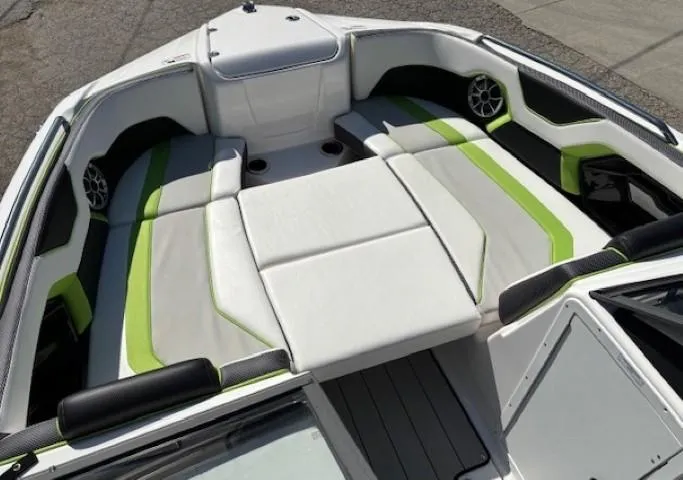 Slide: The Image of 2021 Yamaha Boats 212XE interior with white and green seating, modern design. - 10