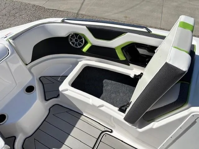 Slide: The Image of 2021 Yamaha Boats 212XE interior with open storage compartment and stylish seating. - 11