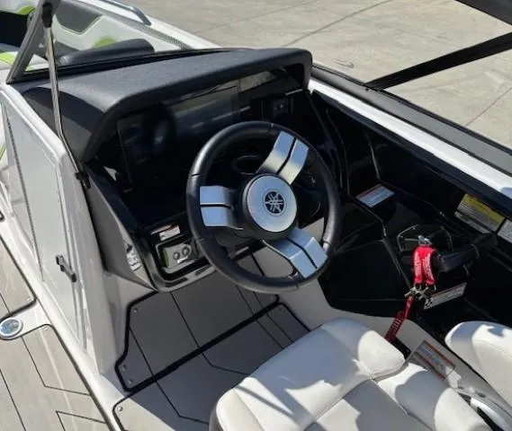 Slide: The Image of 2021 Yamaha Boats 212XE steering wheel and dashboard, featuring modern controls and sleek design. - 17