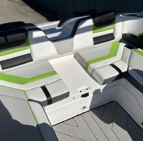 Slide: The Image of 2021 Yamaha Boats 212XE interior with green and black accents. - 21