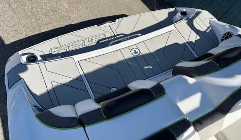 Slide: The Image of 2021 Yamaha Boats 212XE deck with cushioned seating and sleek design. - 23