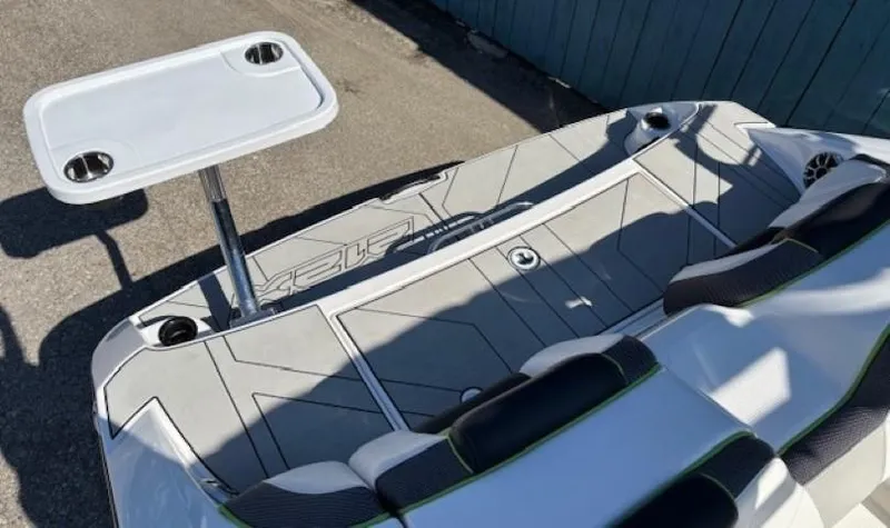 Slide: The Image of 2021 Yamaha Boats 212XE interior with seating and table setup. - 24