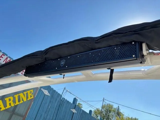 Slide: The Image of Yamaha Boats 2021 212XE with mounted speaker bar under canopy. - 26