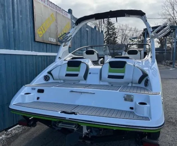 Slide: The Image of 2021 Yamaha Boats 212XE, sleek white design, rear view, outdoor setting. - 4